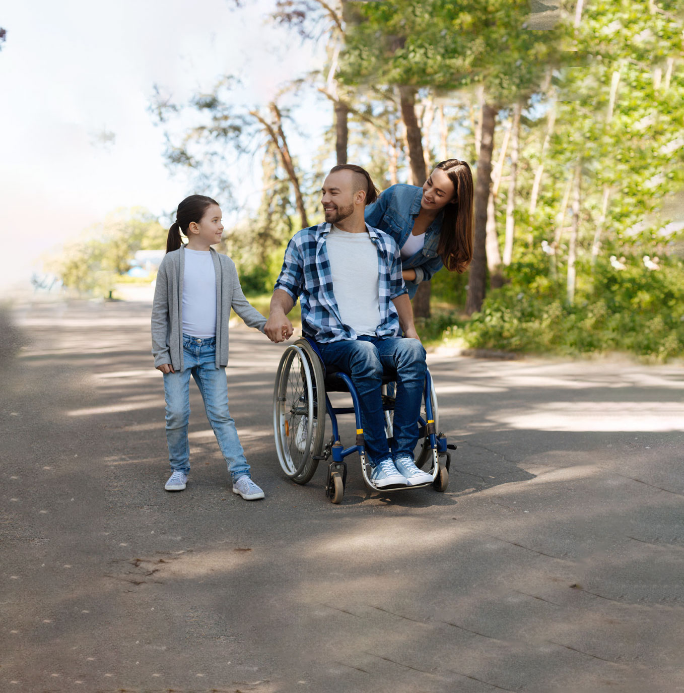 Smiling invalid man sitting on the wheelchair and holding hands with daughter 3